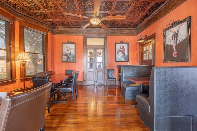 interior space featuring crown molding, wood-type flooring, and ceiling fan