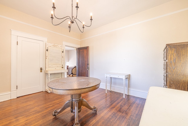 dining area with a chandelier and dark hardwood / wood-style floors