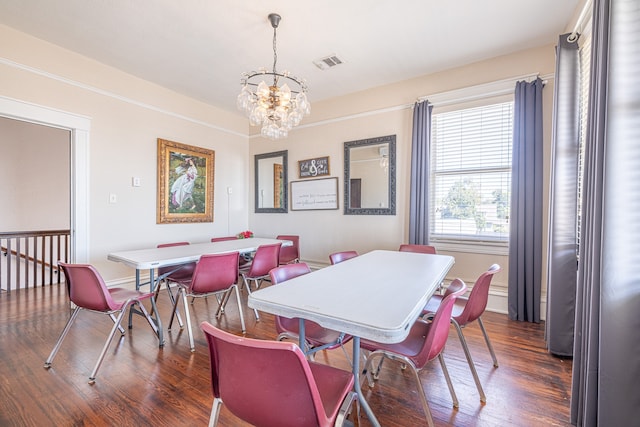 dining room with a chandelier and dark hardwood / wood-style floors