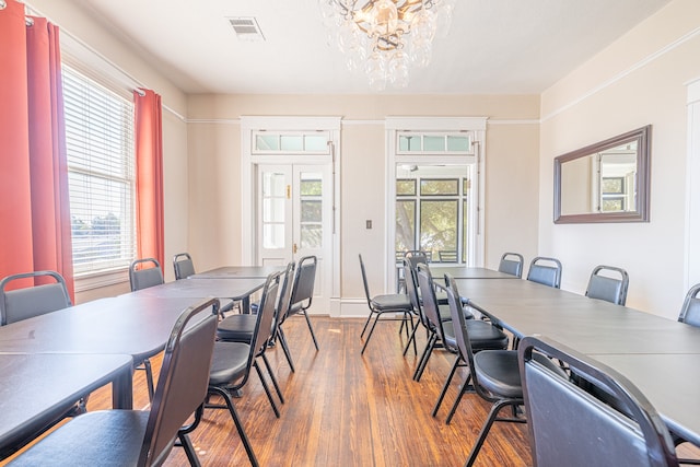 dining room with a chandelier and hardwood / wood-style floors