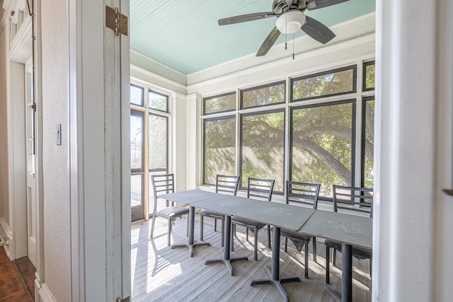 sunroom / solarium featuring ceiling fan