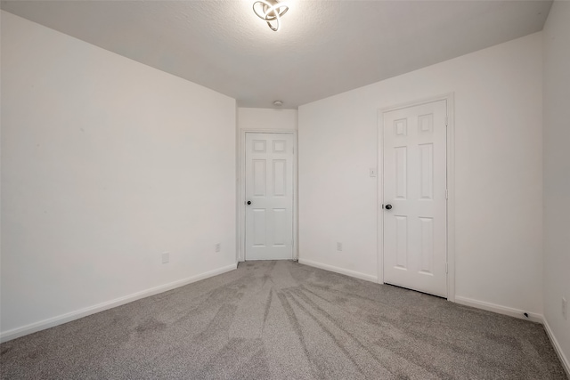 carpeted spare room with a textured ceiling