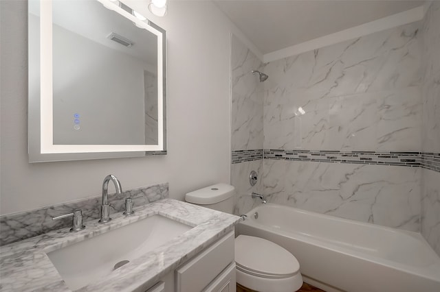 full bathroom with tiled shower / bath combo, toilet, and vanity