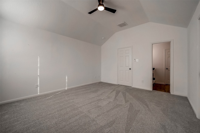 carpeted empty room with ceiling fan and lofted ceiling