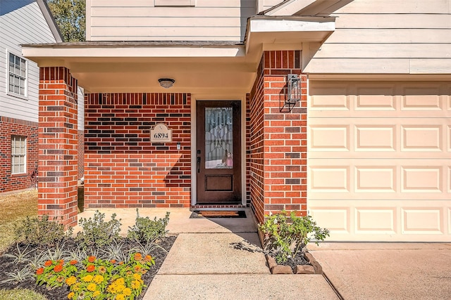 doorway to property with a garage