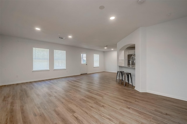 unfurnished living room with light hardwood / wood-style flooring