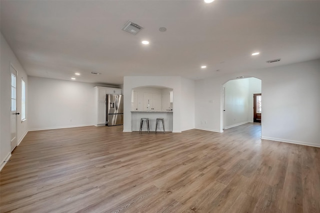 unfurnished living room featuring light wood-type flooring