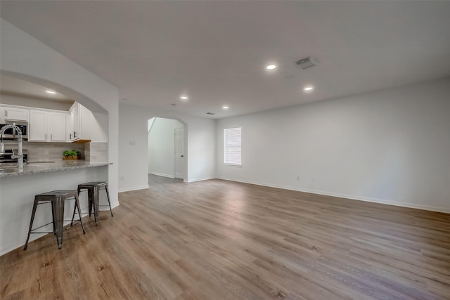 unfurnished living room featuring light wood-type flooring