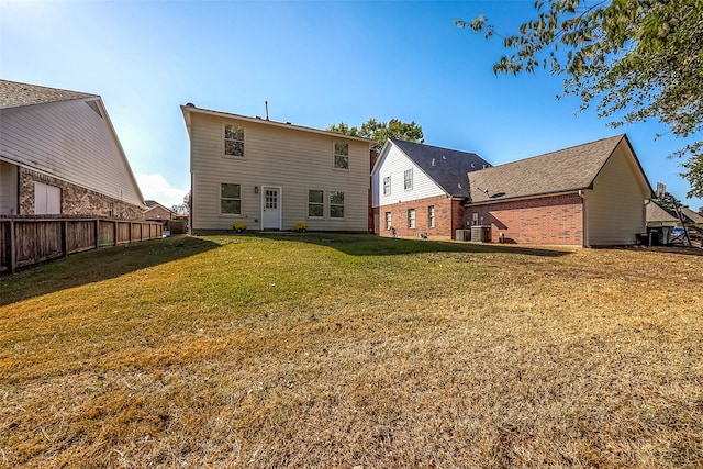 rear view of house featuring a lawn