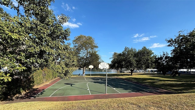 view of sport court with a water view, community basketball court, and a lawn