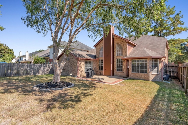 rear view of property with a patio area and a yard