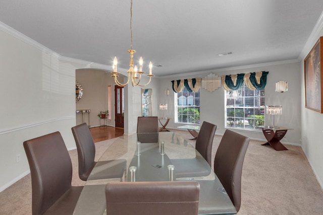 carpeted dining room with crown molding and a notable chandelier