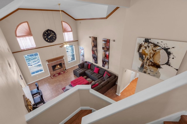 living room featuring hardwood / wood-style floors, high vaulted ceiling, and ceiling fan