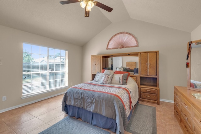 tiled bedroom featuring vaulted ceiling and ceiling fan