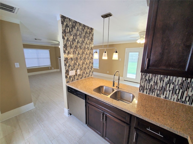 kitchen featuring sink, hanging light fixtures, stainless steel dishwasher, light stone counters, and ornamental molding