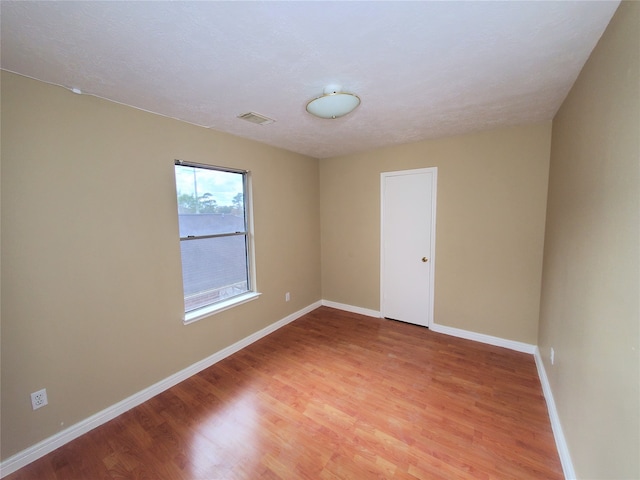 empty room featuring wood-type flooring