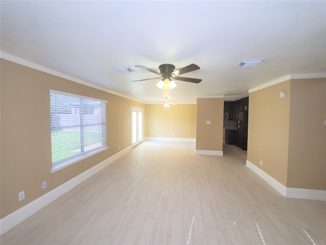 unfurnished room featuring ceiling fan and crown molding