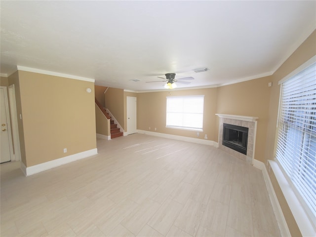 unfurnished living room featuring ceiling fan, crown molding, and a tile fireplace