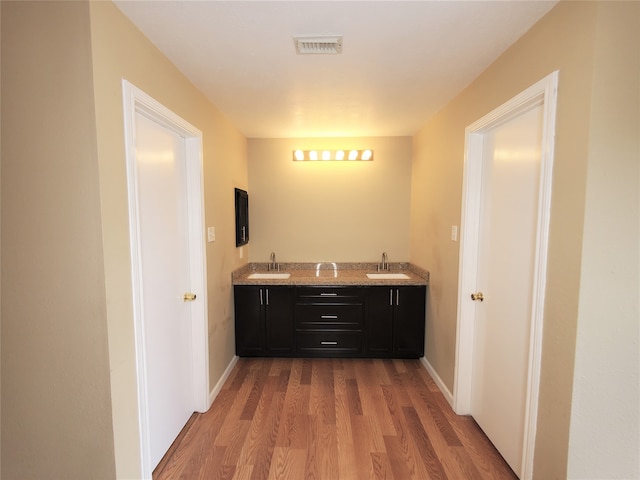 bathroom with vanity and hardwood / wood-style flooring