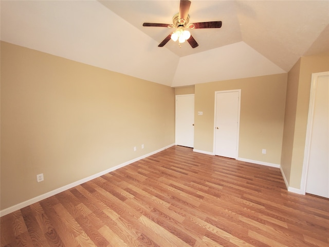 unfurnished bedroom featuring lofted ceiling, light wood-type flooring, and ceiling fan