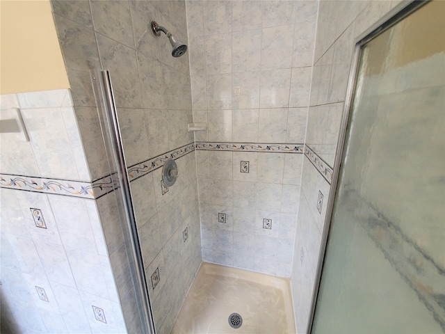 bathroom featuring a shower with door