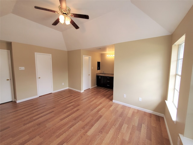 unfurnished room featuring light hardwood / wood-style flooring, ceiling fan, and vaulted ceiling