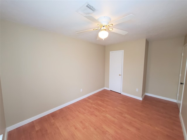 empty room with hardwood / wood-style floors and ceiling fan