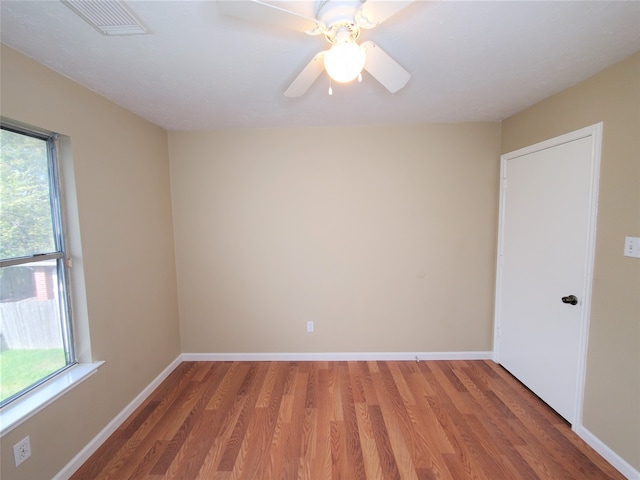 unfurnished room with ceiling fan and hardwood / wood-style floors