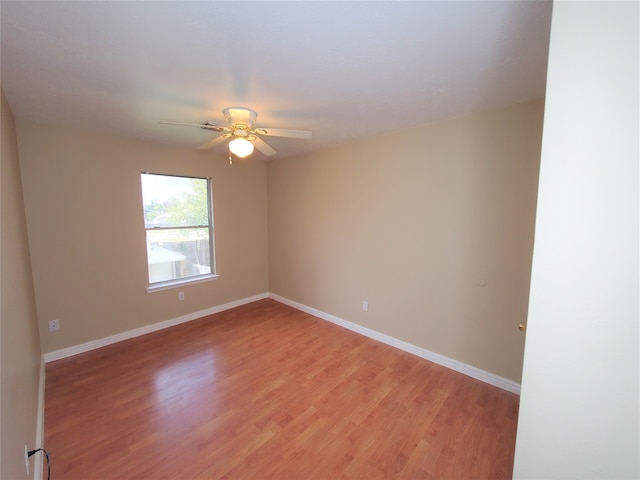 unfurnished room with light wood-type flooring and ceiling fan