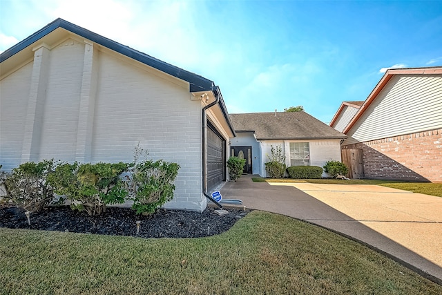 view of property exterior featuring a yard and a garage