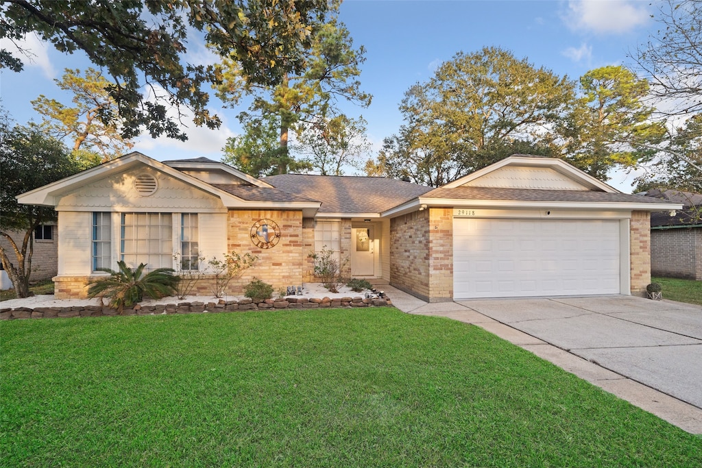 single story home with a front yard and a garage