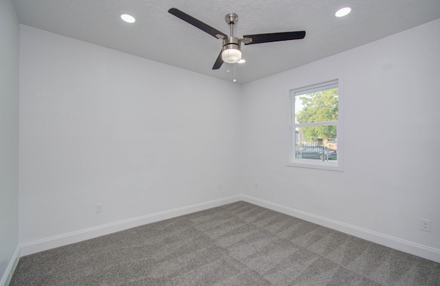 carpeted empty room with a textured ceiling and ceiling fan