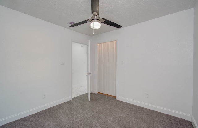 unfurnished room with a textured ceiling and carpet floors