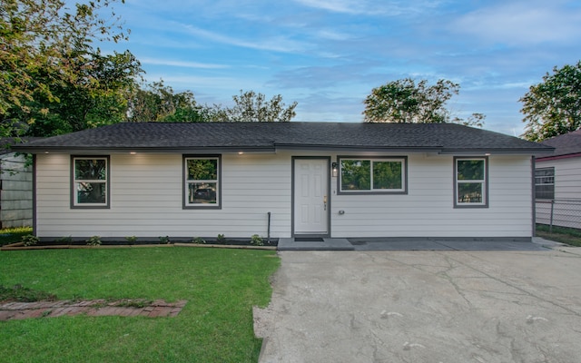 ranch-style house with a patio and a front yard