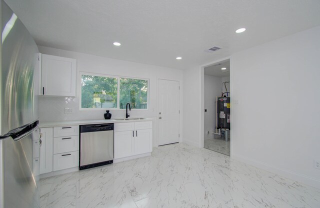 kitchen with white cabinetry, stainless steel appliances, and sink