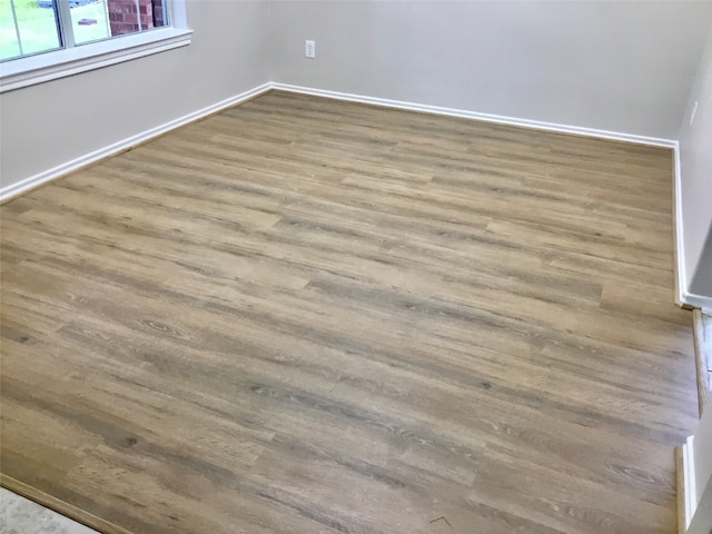 unfurnished room with wood-type flooring