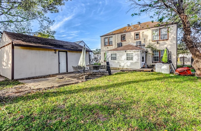 rear view of house with a lawn and a patio