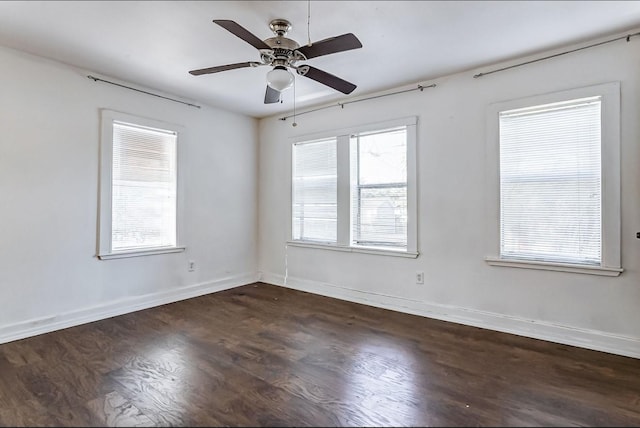 unfurnished room with ceiling fan and dark wood-type flooring