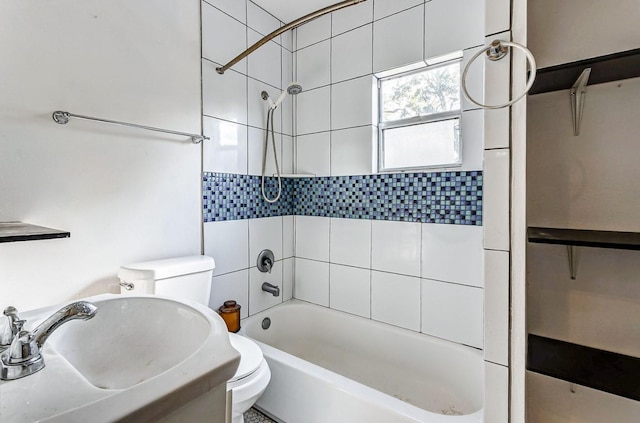 full bathroom featuring toilet, tiled shower / bath, and sink