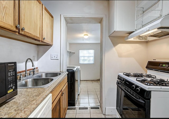 kitchen featuring white appliances, ventilation hood, sink, washer and dryer, and light tile patterned floors