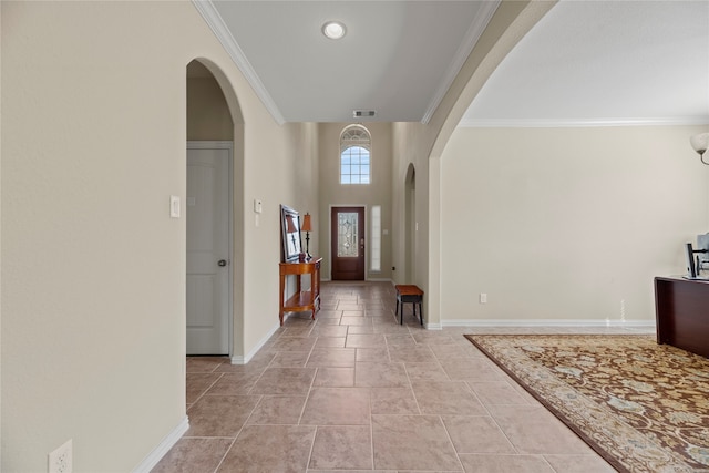 tiled entrance foyer featuring crown molding