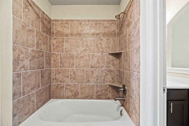 bathroom with vanity and tiled shower / bath combo