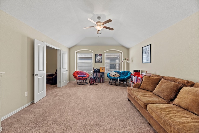 carpeted living room featuring ceiling fan, a textured ceiling, and vaulted ceiling