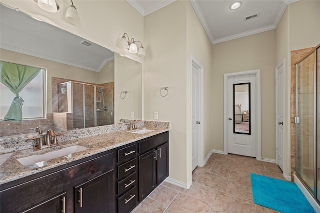 bathroom with vanity, crown molding, tile patterned floors, and a shower with door