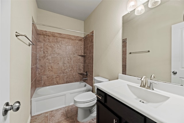 full bathroom featuring vanity, tiled shower / bath combo, and toilet