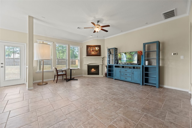 unfurnished living room featuring ceiling fan, a healthy amount of sunlight, light tile patterned floors, and crown molding