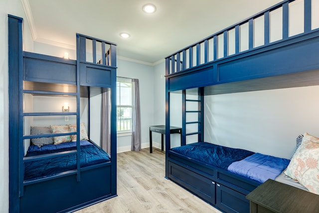 bedroom featuring ornamental molding and light hardwood / wood-style flooring