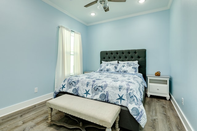 bedroom featuring ornamental molding, wood-type flooring, and ceiling fan