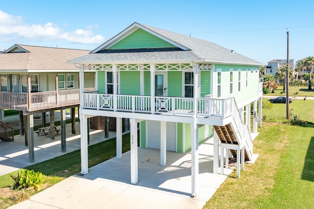 exterior space featuring covered porch, a lawn, and a garage