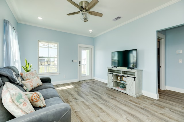 living room featuring ceiling fan, crown molding, and light wood-type flooring